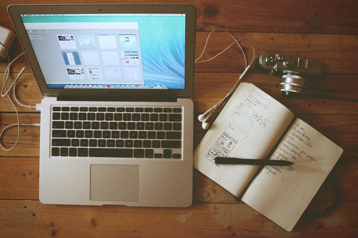 Modern workspace setup with laptop and notebook